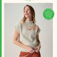 Sirdar knitting pattern cover for 'Loveful' in the Bio Blend yarn range. The cover features a model wearing a cream-colored mock-neck knit sweater with orange embroidered leaf details on the chest, paired with rust-colored trousers.
